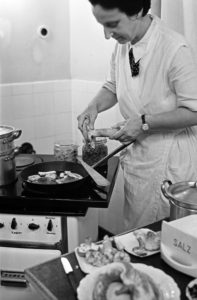 A woman preparing a meal with mixed mushrooms, Germany 1930s. A woman preparing a meal with mixed mushrooms, Germany 1930s.